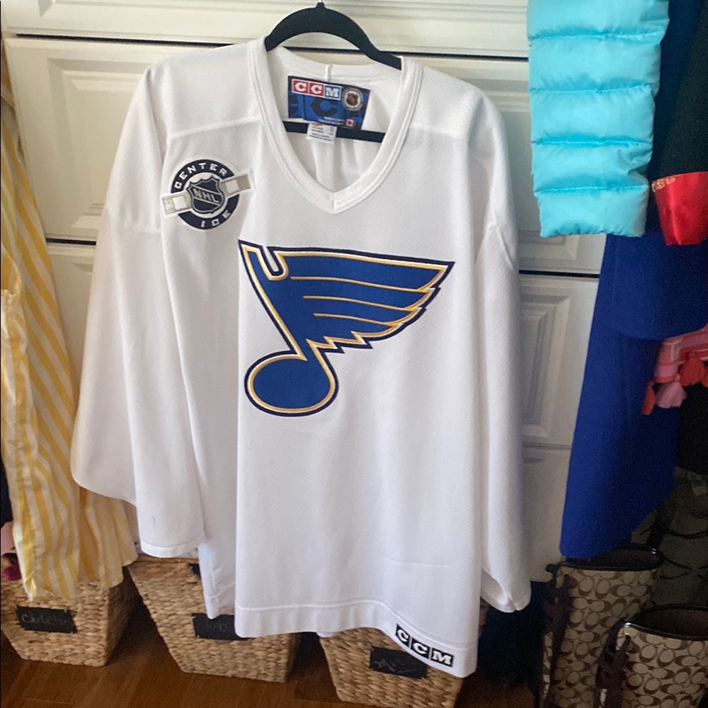White CCM Hockey Jersey with Blue and Yellow Logo